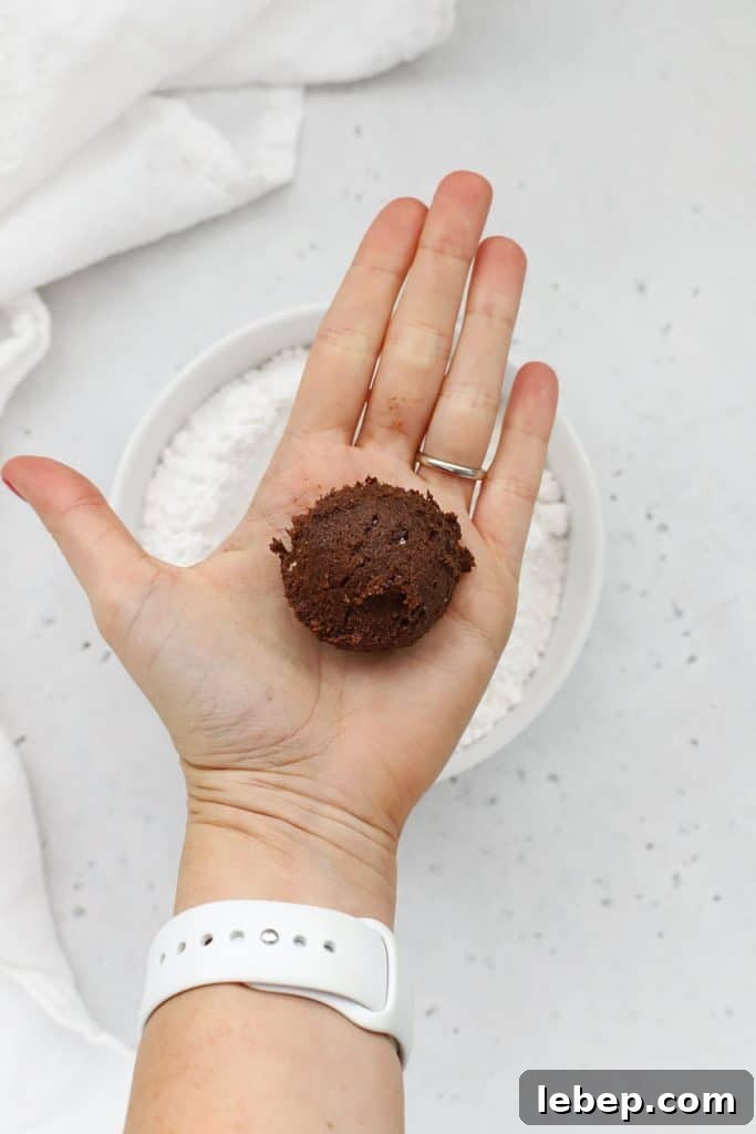 Gluten-Free Peppermint Chocolate Crinkle Cookies Recipe 8 Scooped ball of peppermint chocolate crinkle cookie dough