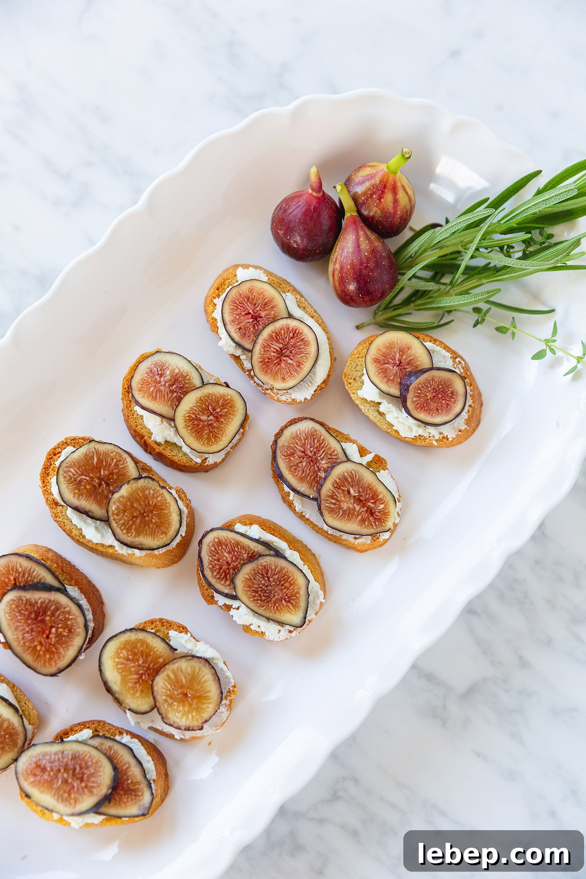 Sliced figs on goat cheese crostini toasts