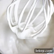 Homemade Marshmallows Without Corn Syrup: Simple Recipe 3 a kitchen aid whisk attachment with marshmallow cream on it