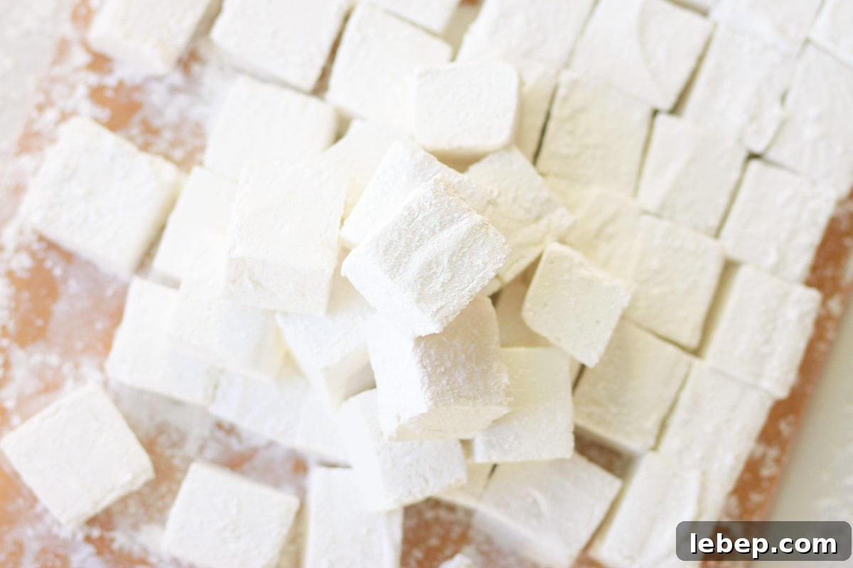 Homemade Marshmallows Without Corn Syrup: Simple Recipe 5 homemade marshmallows in a pile on a cutting board