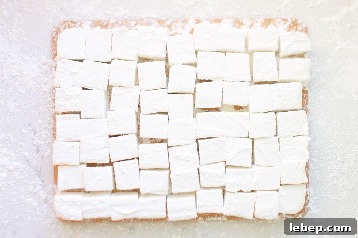 Homemade Marshmallows Without Corn Syrup: Simple Recipe 6 homemade marshmallows on a cutting board