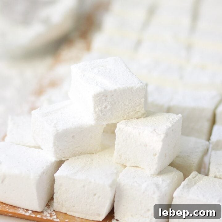 homemade marshmallows in a pile on a cutting board