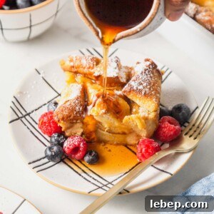 Brioche French Toast Casserole Recipe for Brunch or Holidays 13 french toast casserole with berries and maple syrup poured over it.