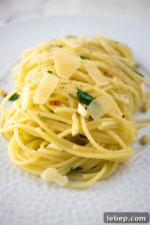 spaghetti with garlic and olive oil topped with parmesan and parsley
