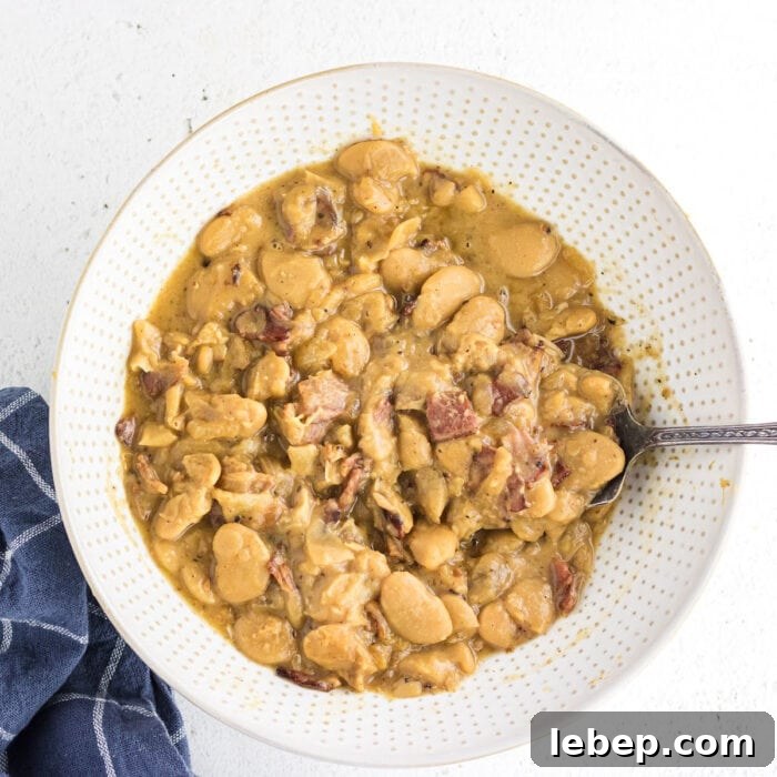 Overhead view of a bowl of butterbeans with bacon.