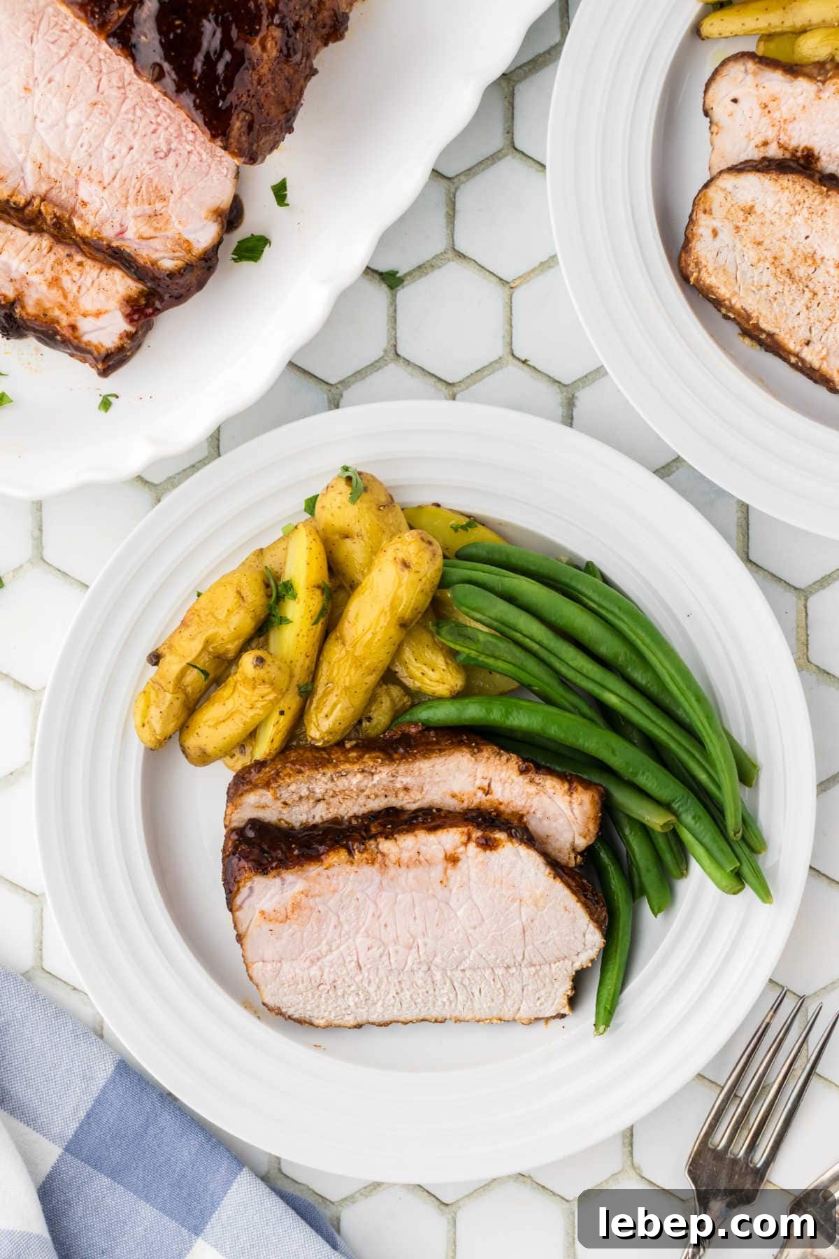 Slices of pork loin served on a white plate.