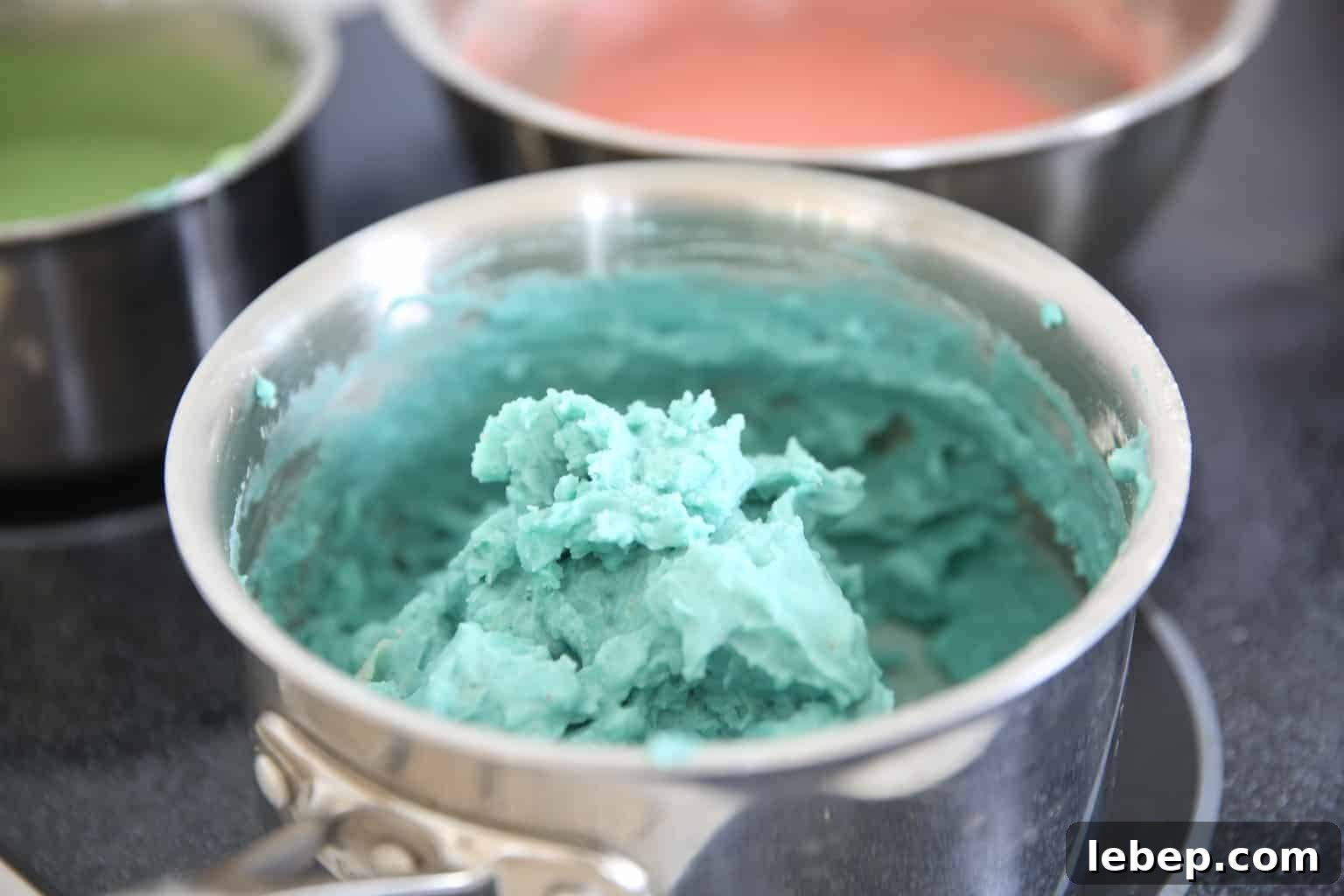 Aromatic Homemade Play Dough Recipe for Calming Sensory Play 3 almost finished blue play dough on stove top in medium pot