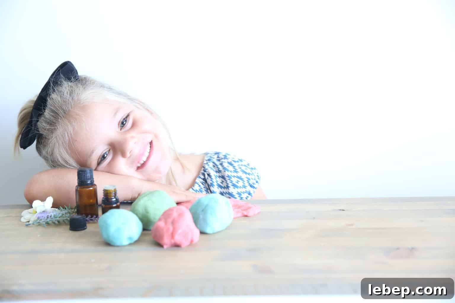 Aromatic Homemade Play Dough Recipe for Calming Sensory Play 5 freshly made play doh on wooden table