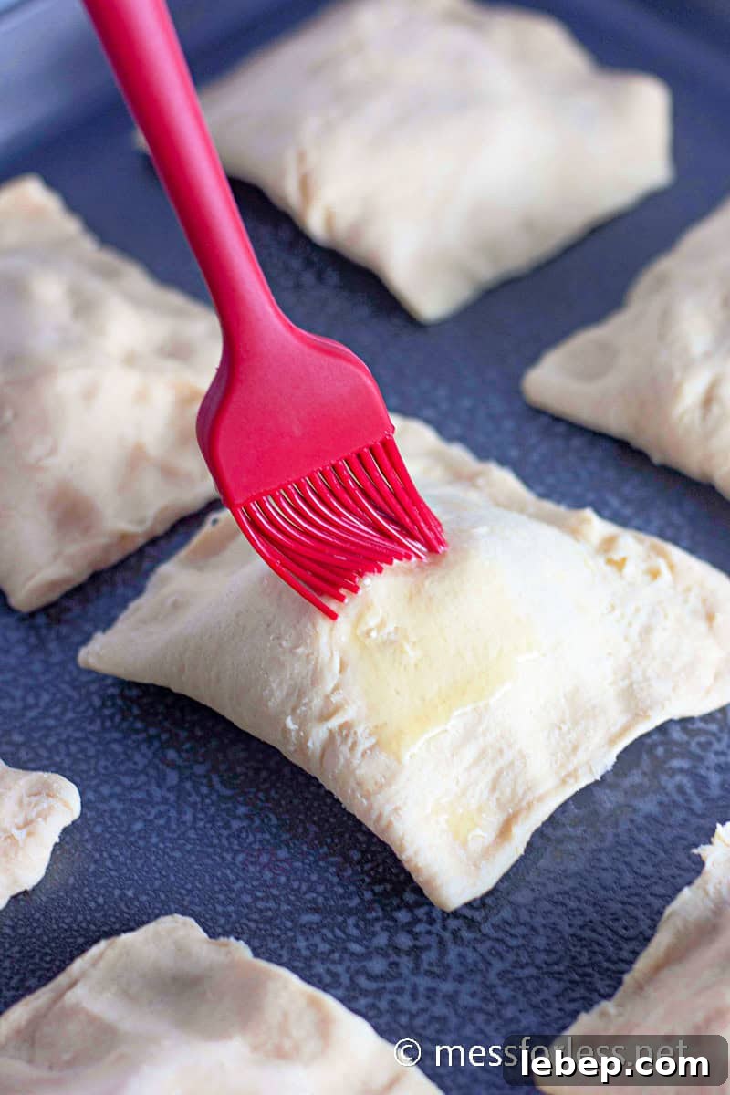 Cheesy Chicken Crescent Bake with Puff Pastry Squares 10 brushed butter on a crescent square