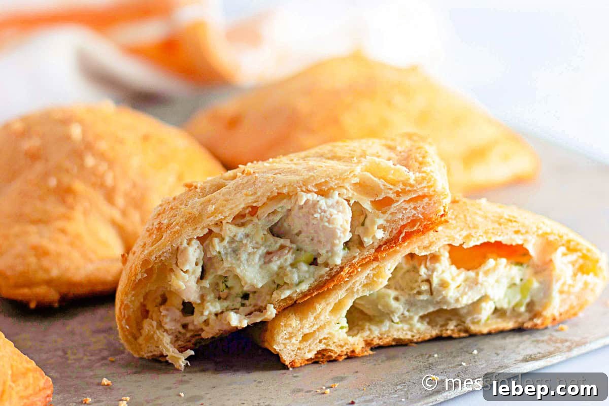 Cheesy Chicken Crescent Bake with Puff Pastry Squares 4 sliced chicken crescent pocket on cutting board