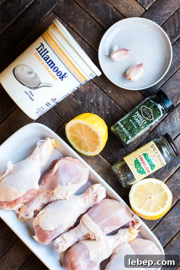 Greek Slow Cooker Chicken Drumsticks with Lemon & Oregano 3 yogurt, drumsticks, garlic and seasonings on a table