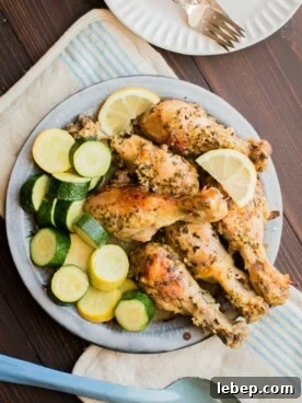 Greek Slow Cooker Chicken Drumsticks with Lemon & Oregano 7 greek chicken thighs on a pie tin with squash.