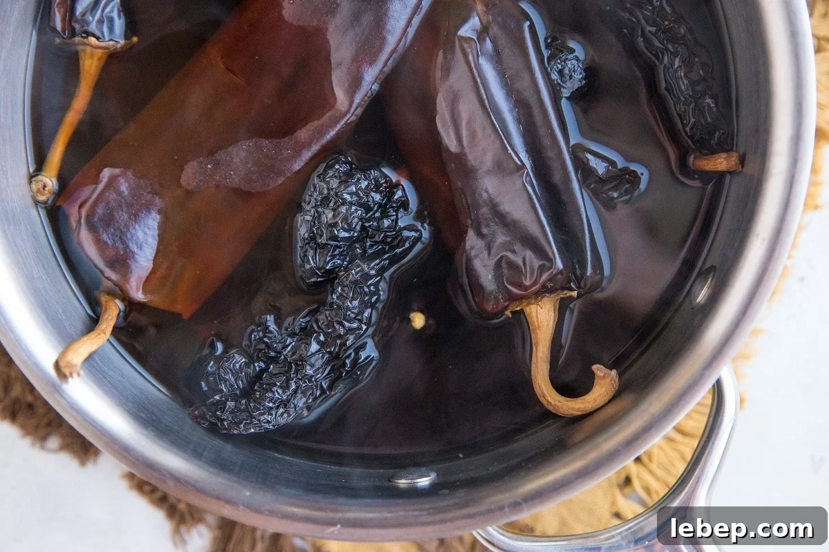 Chilis soaking in water in a saucepan