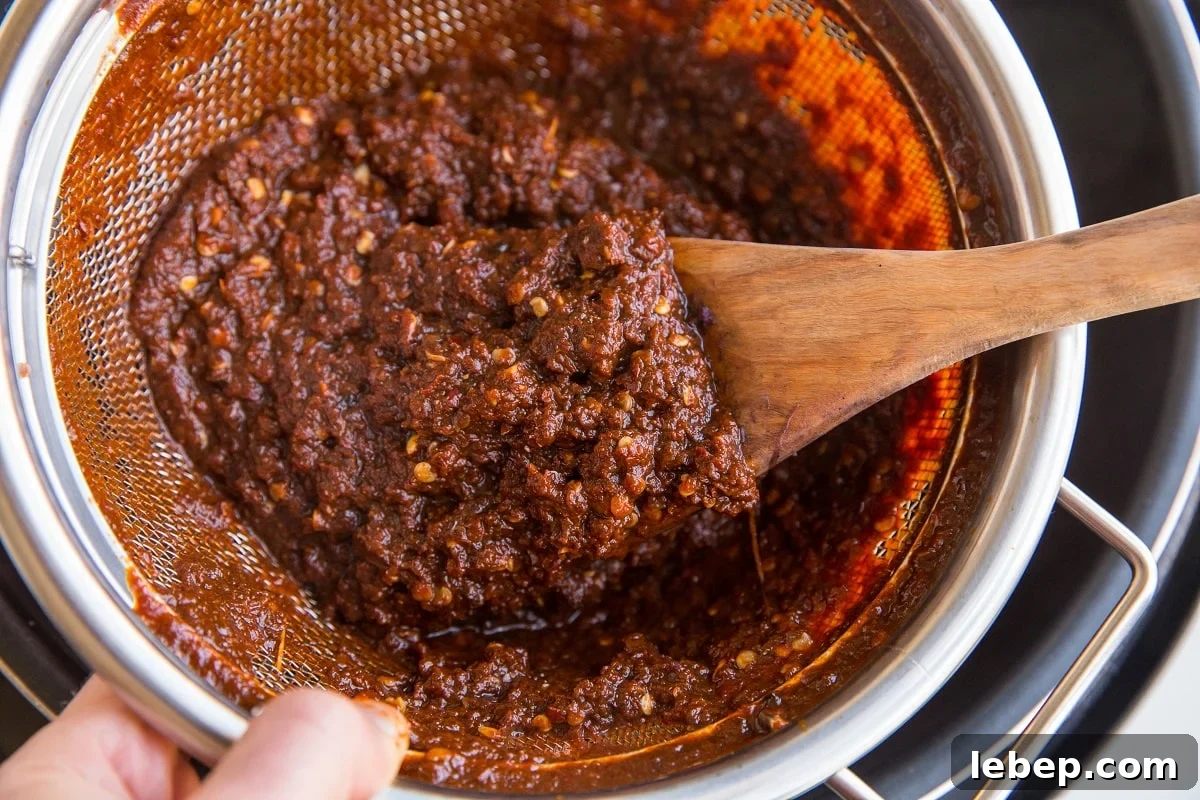 Chile pulp in a strainer from red chile sauce