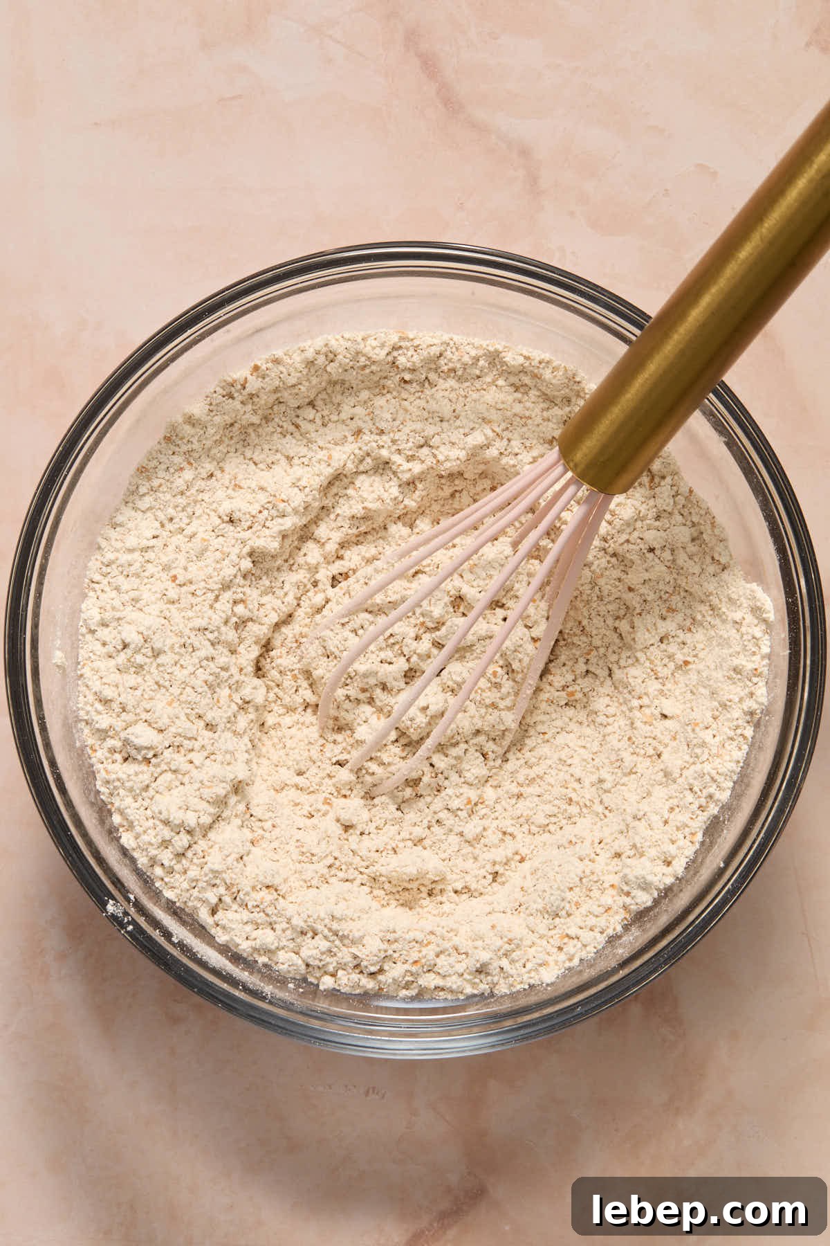 Spelt Flour Peanut Butter Banana Muffins — Naturally Sweetened 4 Dry ingredients for muffins whisked together in a smaller glass bowl.
