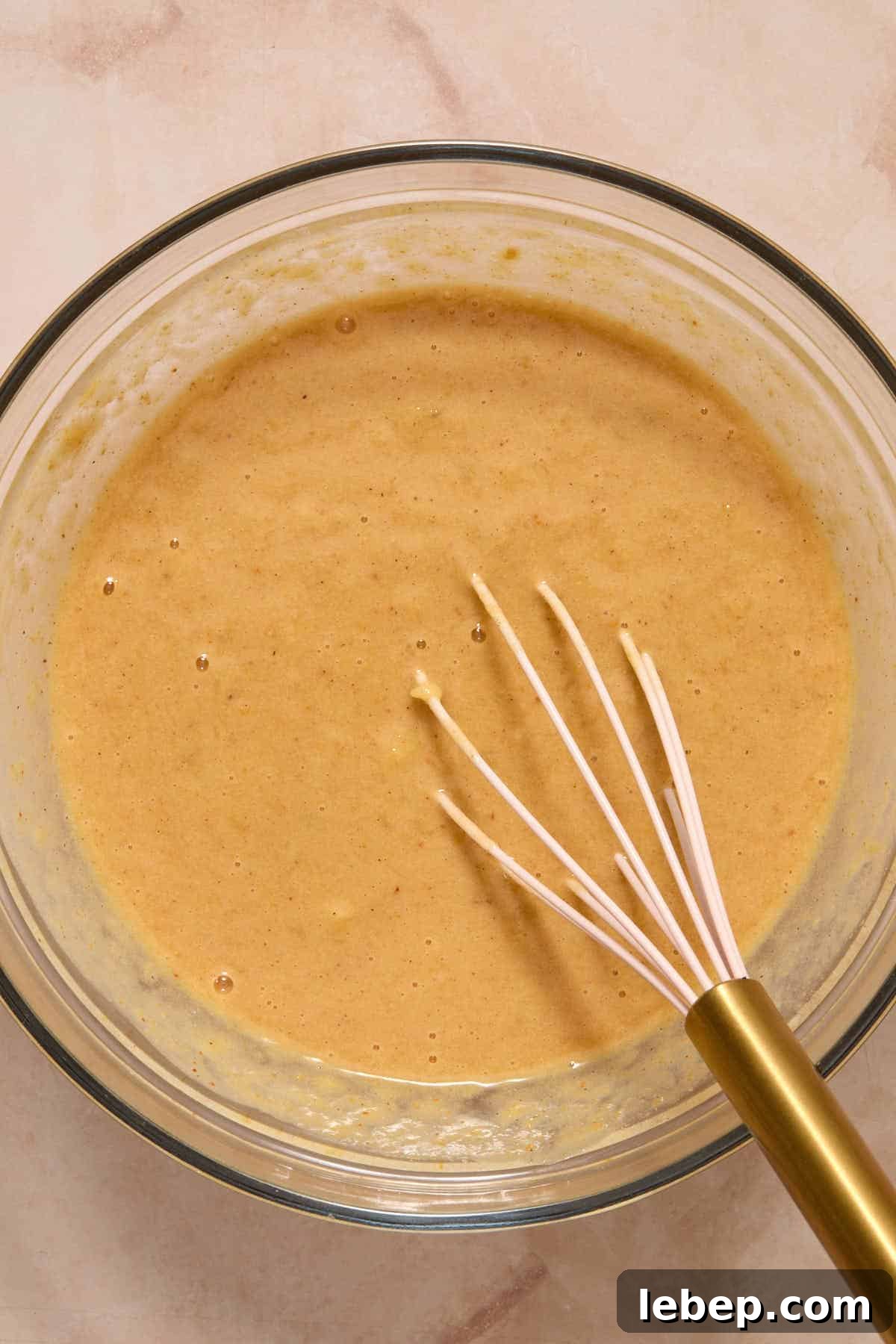 Spelt Flour Peanut Butter Banana Muffins — Naturally Sweetened 6 Wet ingredients for muffin batter whisked together in a glass bowl.