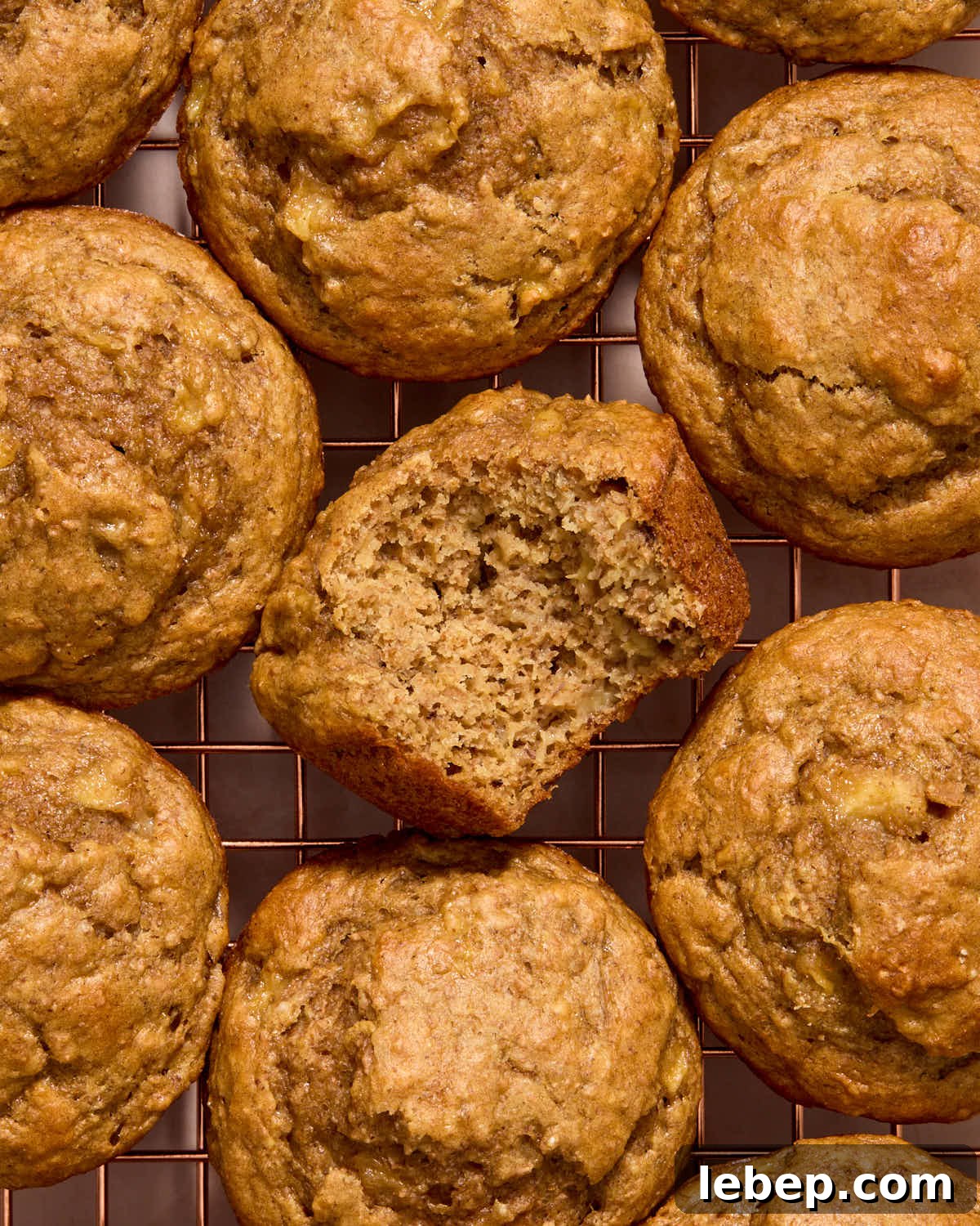 Spelt Flour Peanut Butter Banana Muffins — Naturally Sweetened 10 Overhead of muffins on a wire rack with a bite taken from one.