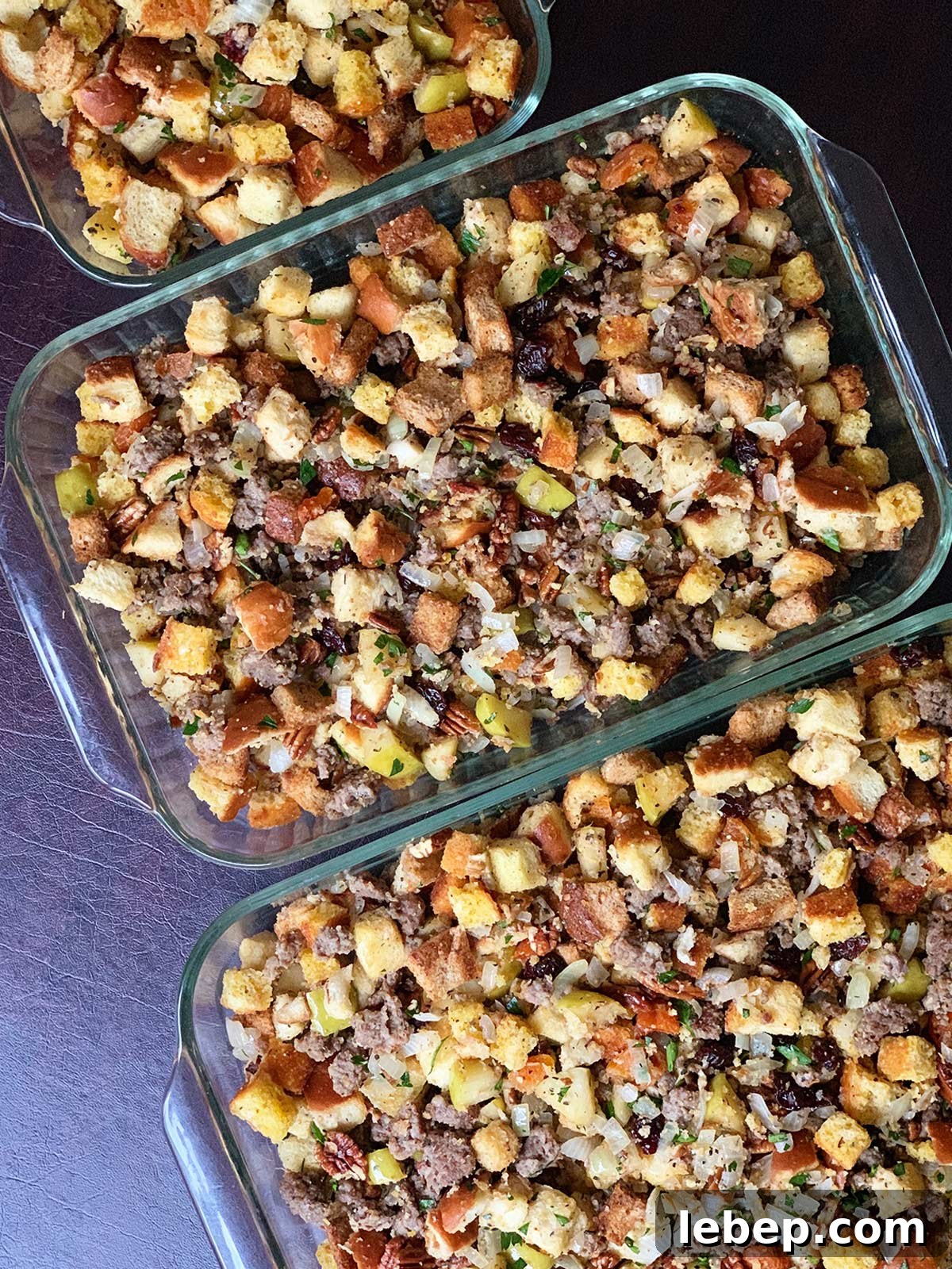 Sage Sausage Stuffing Recipe for Thanksgiving and Holiday Dinners 2 3 trays of sage sausage stuffing in line.