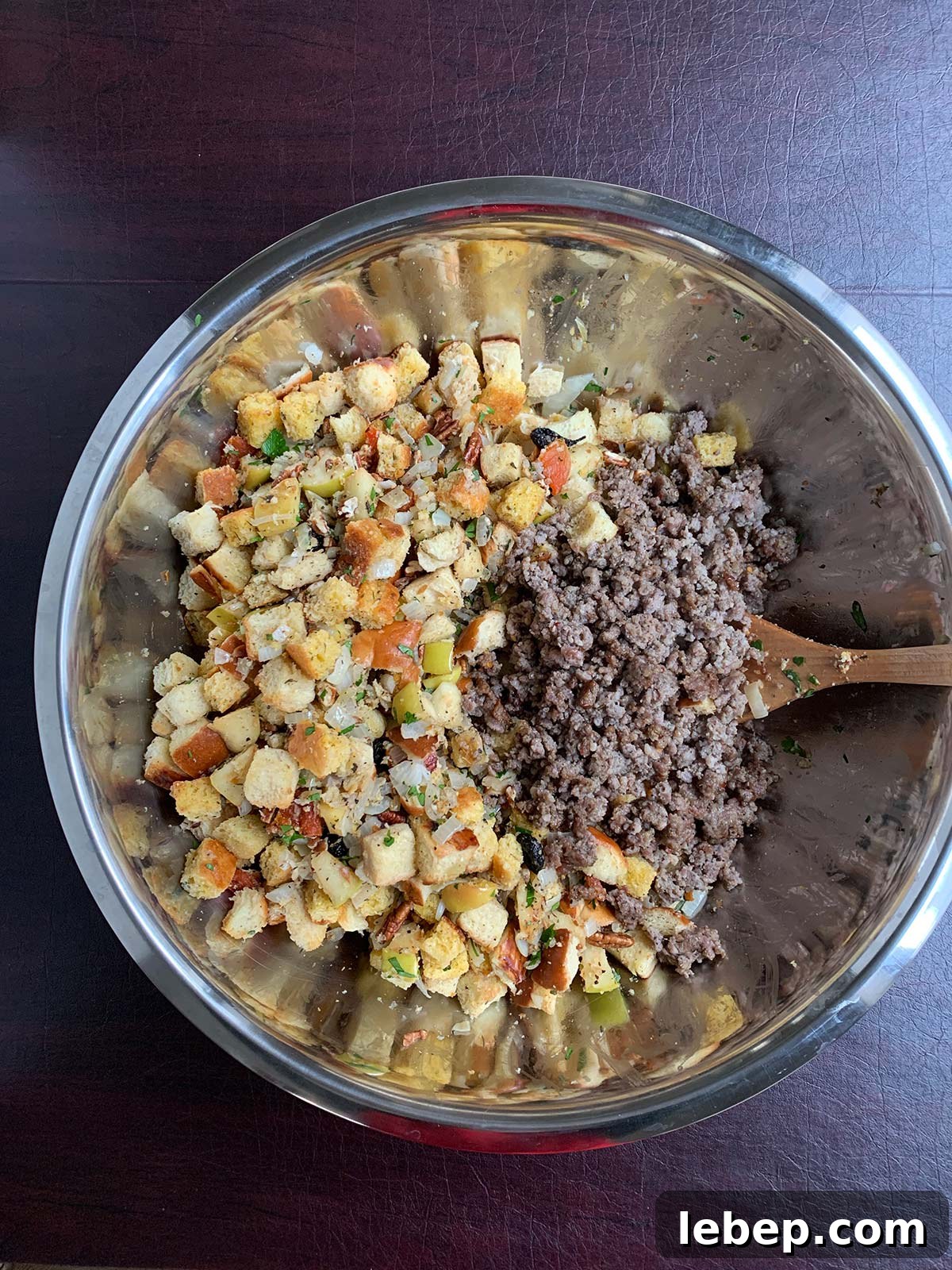 Sage Sausage Stuffing Recipe for Thanksgiving and Holiday Dinners 11 Stuffing mixed together in large bowl with crumbled cooked sausage added in.