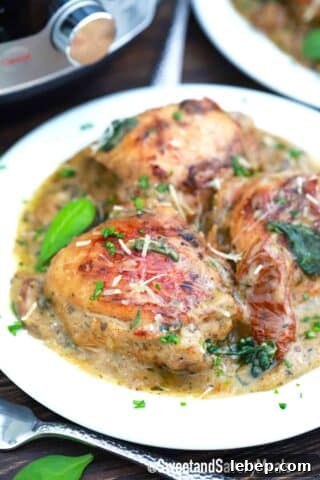 a plate of creamy and browned tuscan chicken